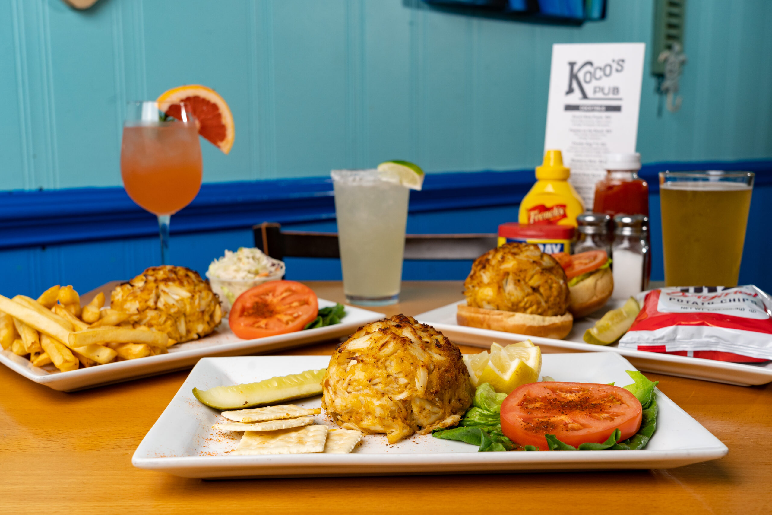 Table with Crab Cake Platters and Drinks