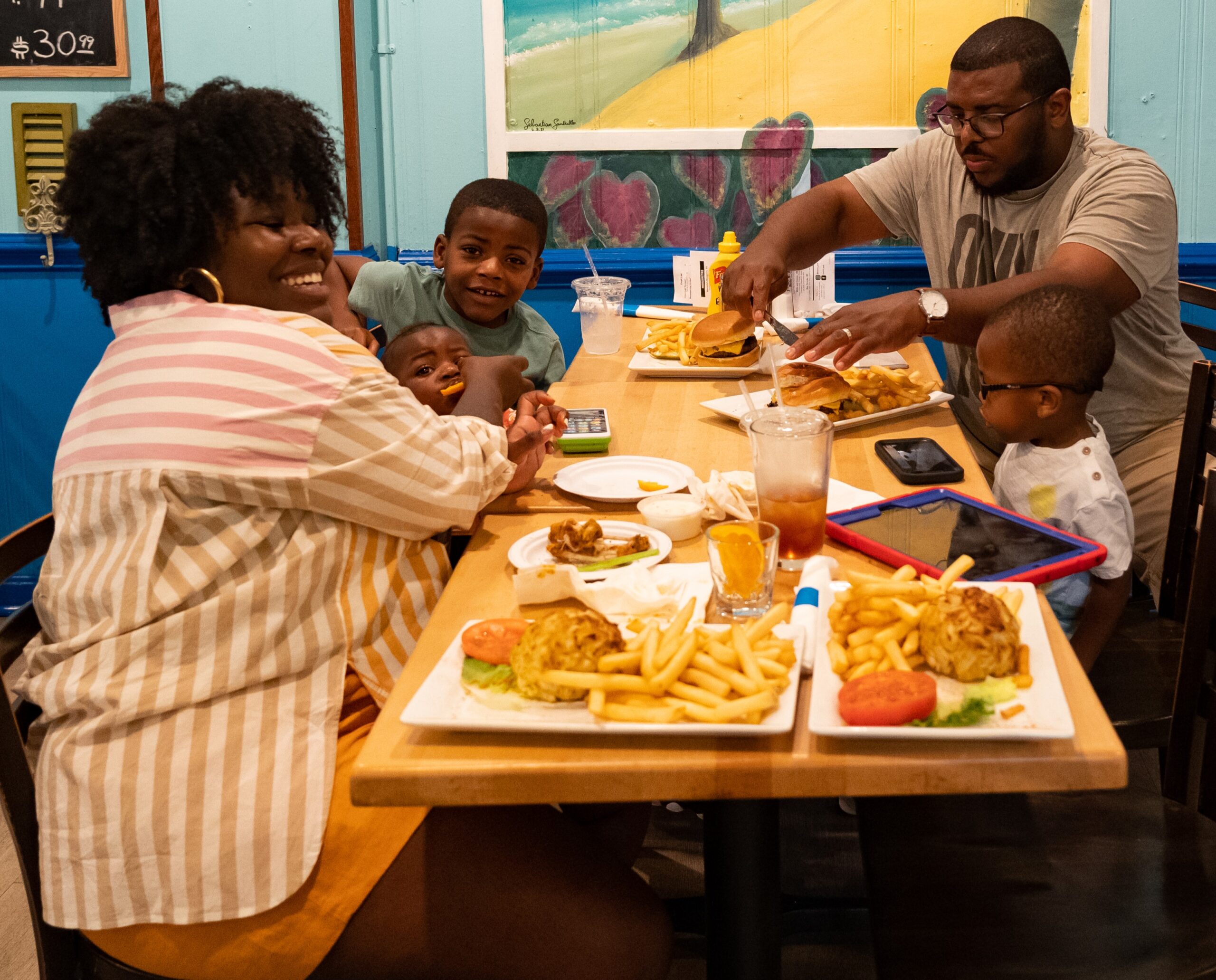 Parents and kids eating at a booth